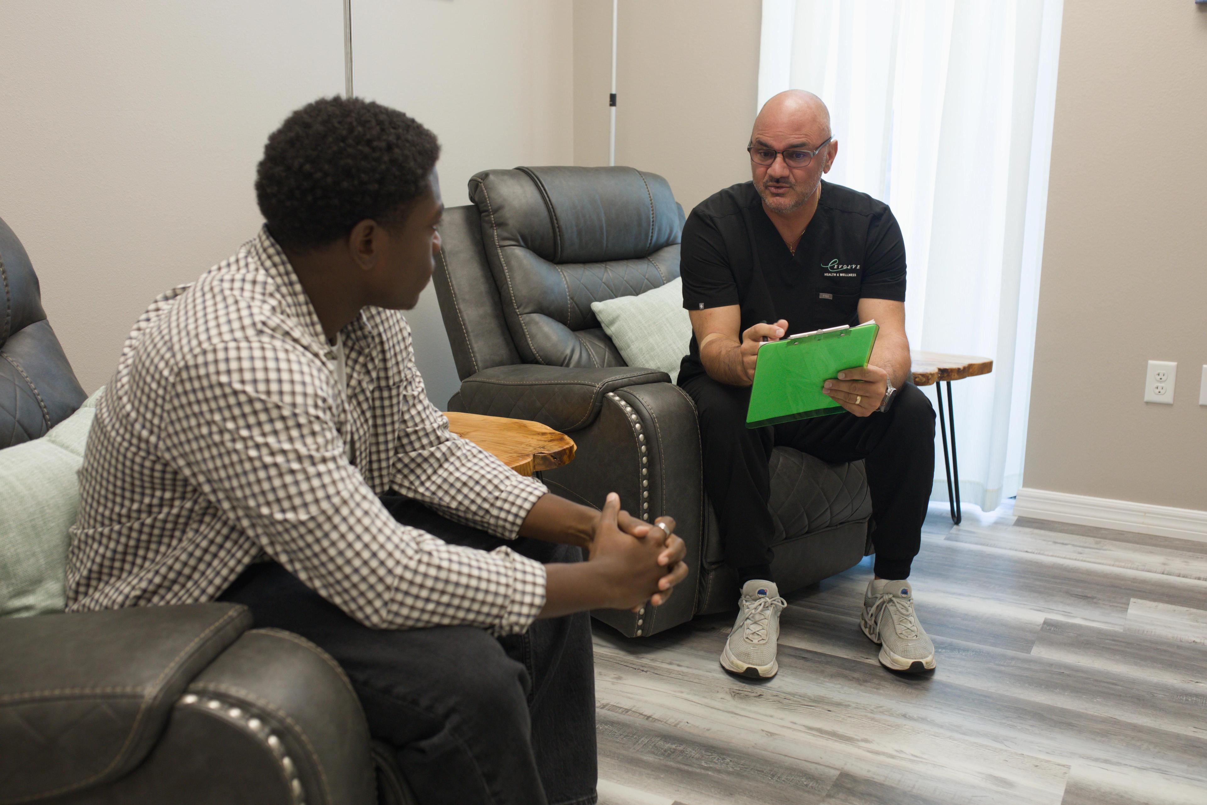 Physician reviewing TRT lab results and hormone panel for male patient at Evolve Health Saint Cloud FL Physician reviewing TRT lab results and hormone panel for male patient at Evolve Health Saint Cloud FL